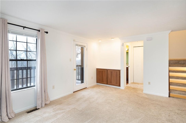 spare room with light carpet and ornamental molding