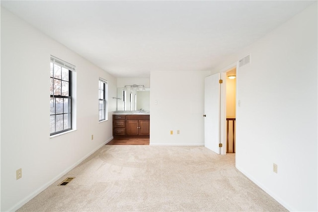 carpeted spare room with sink