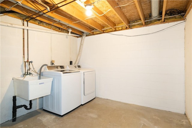 laundry area featuring washing machine and clothes dryer and sink