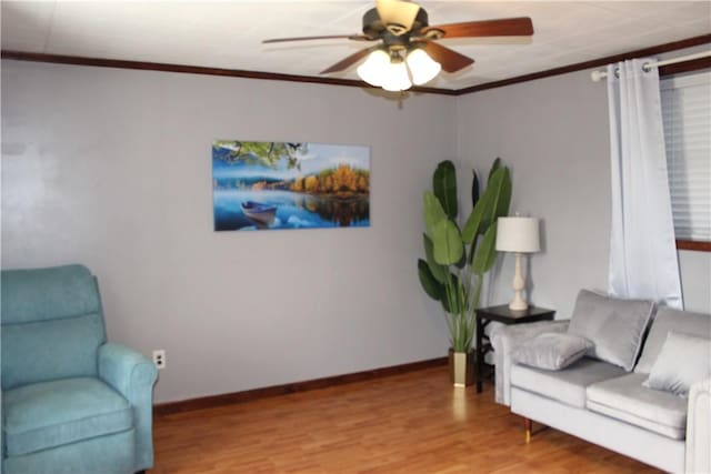 living area with ceiling fan, light wood-type flooring, and ornamental molding