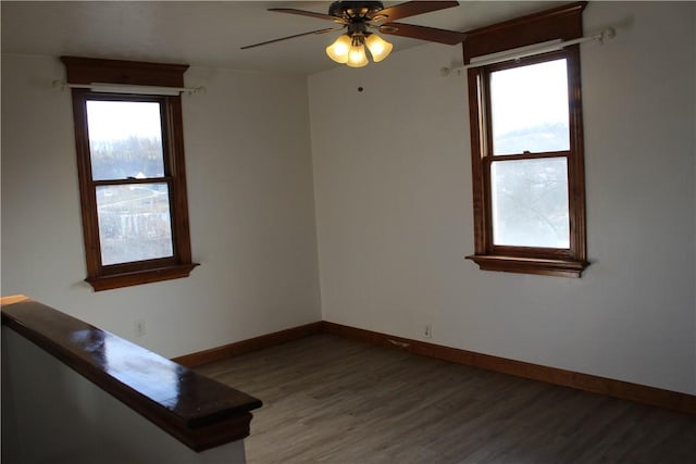 empty room featuring dark hardwood / wood-style floors and ceiling fan