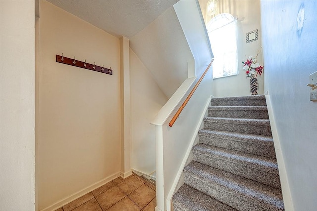 stairway featuring tile patterned floors