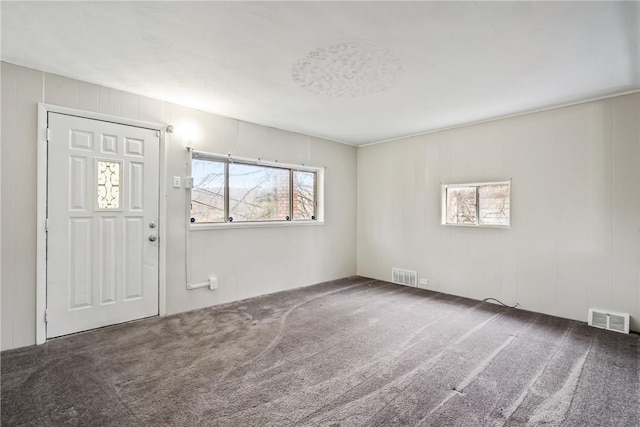 entryway featuring dark carpet