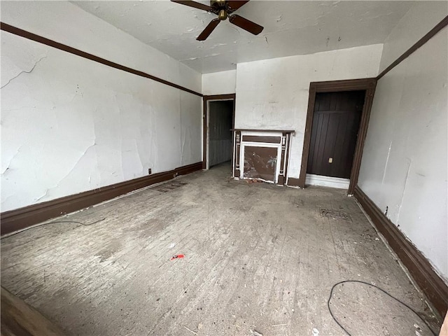 unfurnished living room with ceiling fan