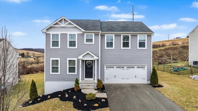 view of front of property with a front yard and a garage