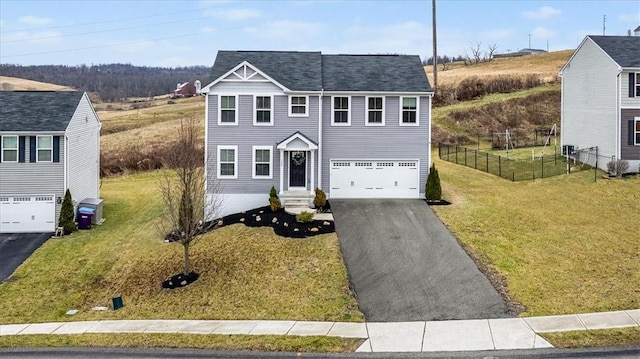 view of front of home with a garage and a front lawn