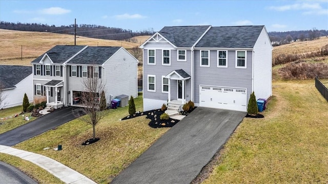 view of front of property with a front yard and a garage