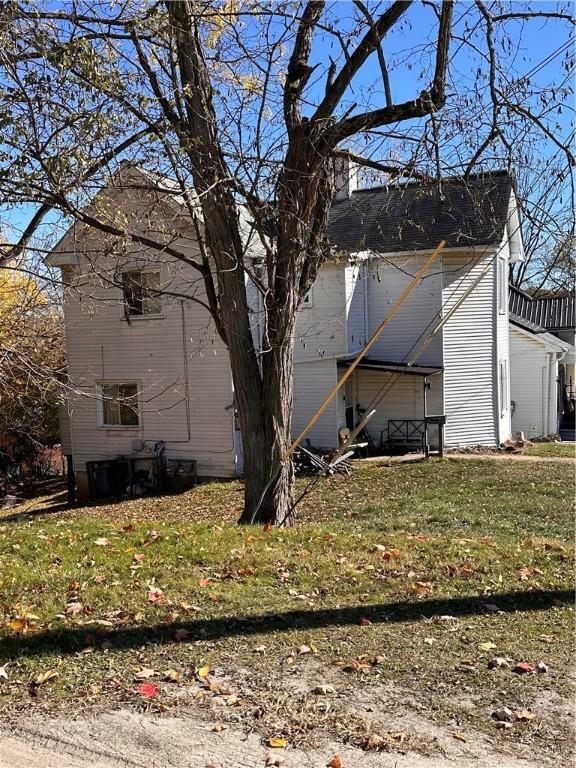 view of side of property with a lawn