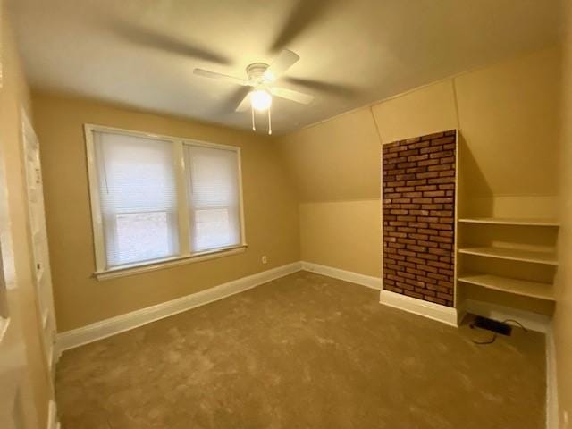 additional living space with ceiling fan, dark carpet, and lofted ceiling