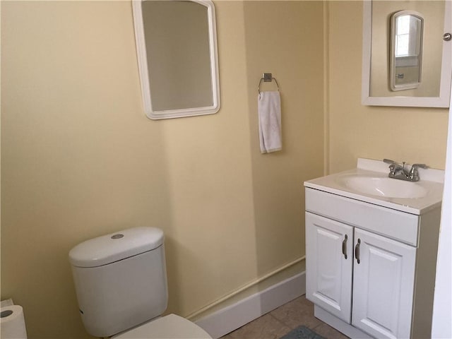 bathroom featuring tile patterned flooring, vanity, and toilet