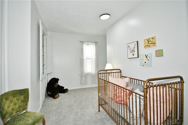 bedroom featuring light colored carpet and a crib