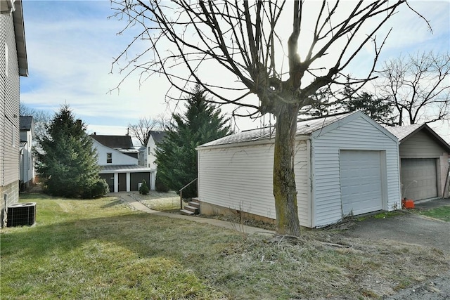 garage featuring a yard and central AC unit