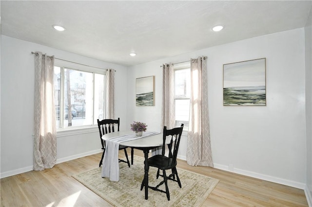 dining space with light hardwood / wood-style floors