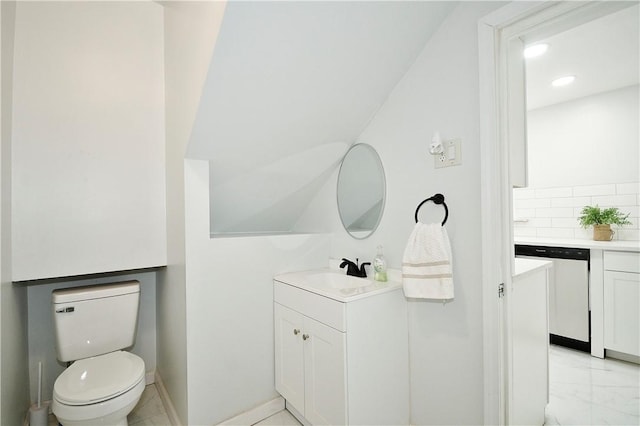 bathroom featuring decorative backsplash, vanity, and toilet