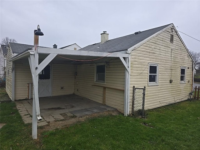 rear view of house with a lawn