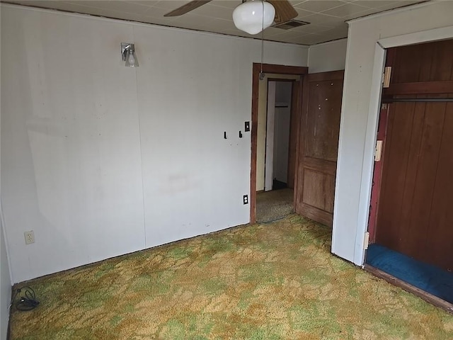 unfurnished bedroom with carpet flooring and ceiling fan