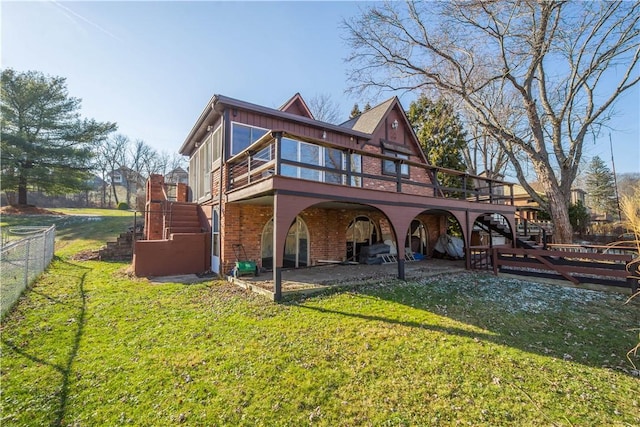 back of house featuring a wooden deck, a patio area, and a yard