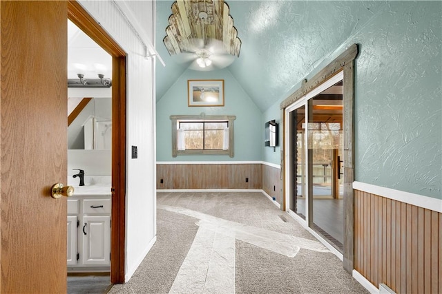 bathroom with ceiling fan and lofted ceiling