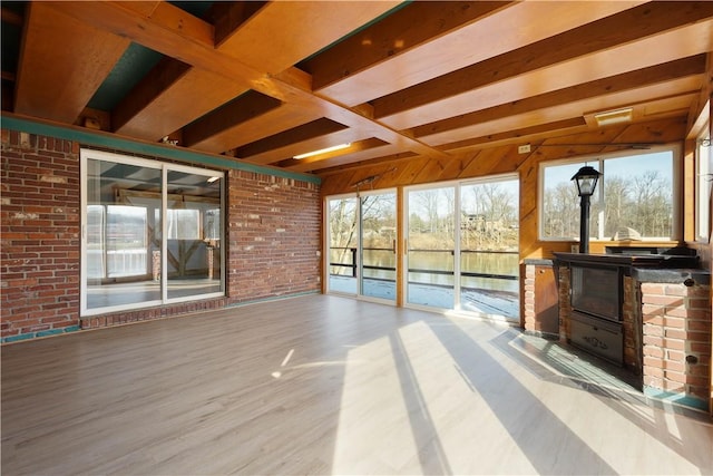 unfurnished sunroom featuring beamed ceiling