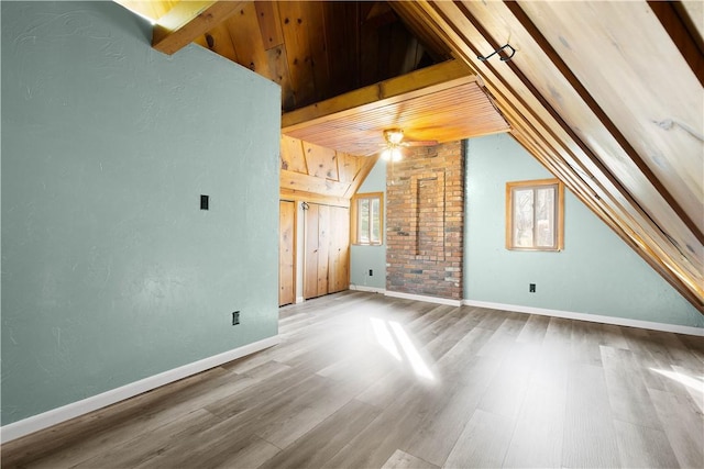 additional living space with hardwood / wood-style floors, ceiling fan, and vaulted ceiling