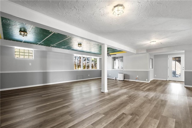 basement with wood-type flooring and a textured ceiling