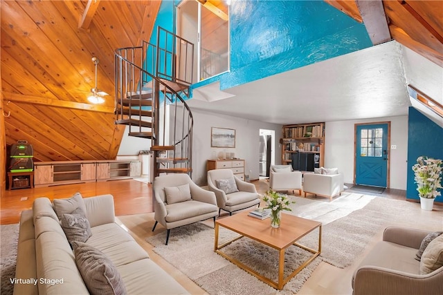 living room featuring beamed ceiling, ceiling fan, wooden ceiling, and high vaulted ceiling