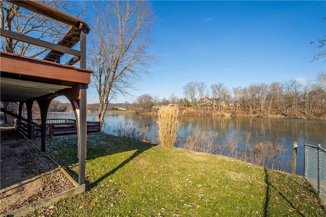 dock area featuring a lawn and a water view