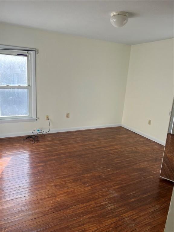 empty room with dark hardwood / wood-style floors