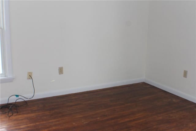 empty room with dark wood-type flooring