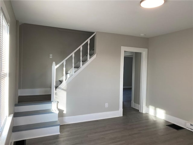 stairs featuring hardwood / wood-style floors