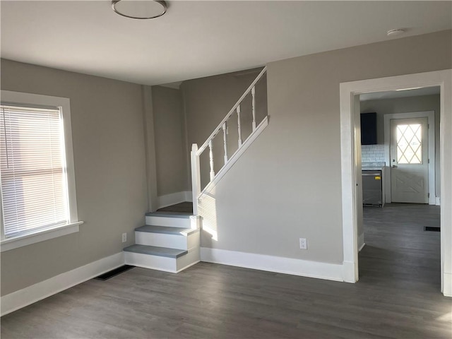 stairway with hardwood / wood-style floors