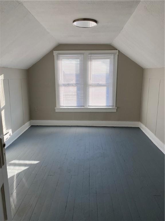 bonus room featuring vaulted ceiling and hardwood / wood-style flooring