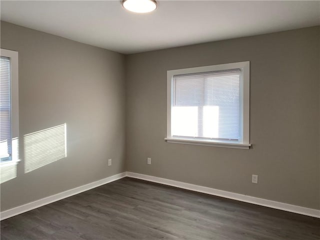 spare room with dark hardwood / wood-style floors