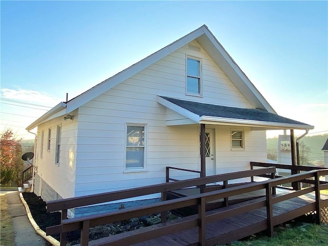 back of property featuring covered porch