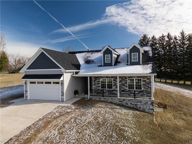 view of front of property featuring a porch and a garage