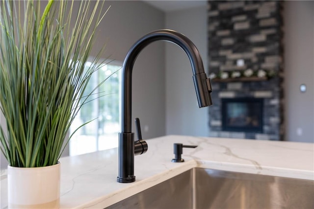 details with light stone countertops and sink