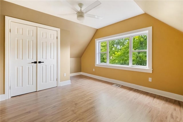 additional living space featuring ceiling fan, lofted ceiling, and light wood-type flooring