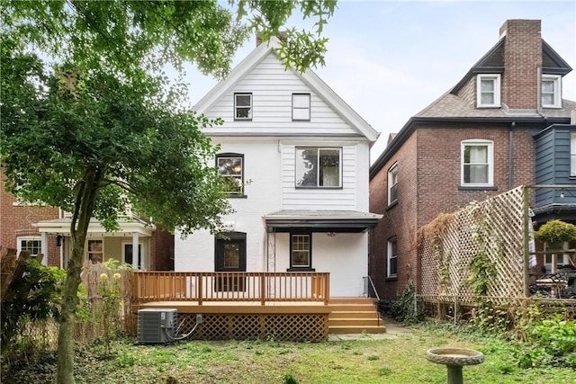 rear view of property with central AC unit