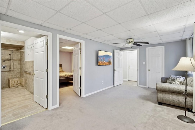 unfurnished living room featuring ceiling fan and light carpet