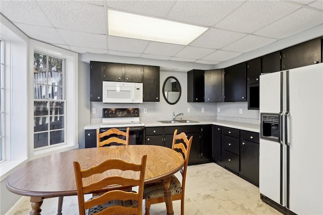 kitchen featuring sink and white appliances