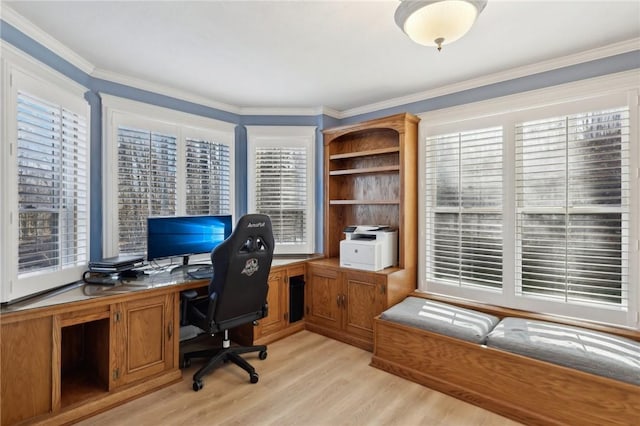 office space with a healthy amount of sunlight, light wood-type flooring, and ornamental molding