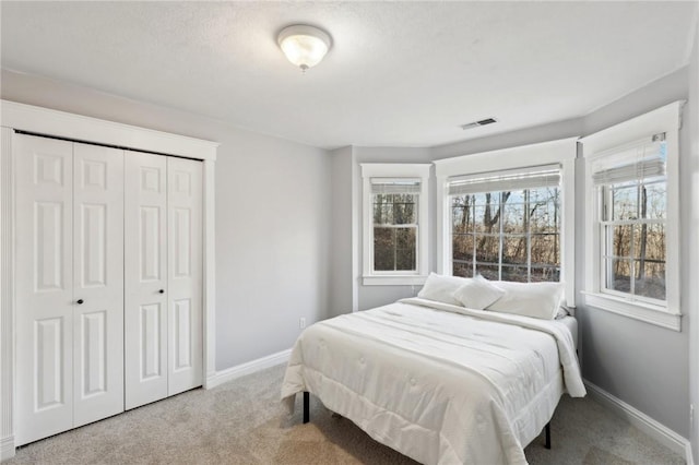 bedroom with carpet and a closet