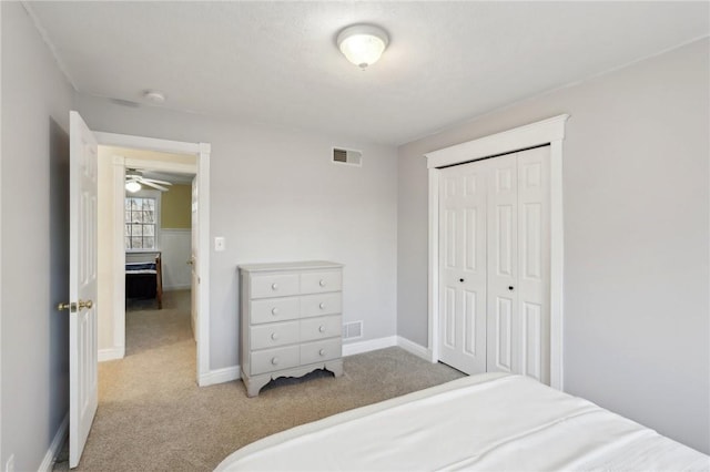 bedroom with light carpet and a closet