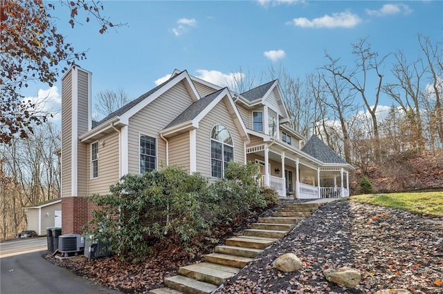 view of property exterior with central AC unit and a porch