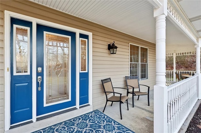 view of exterior entry featuring a porch