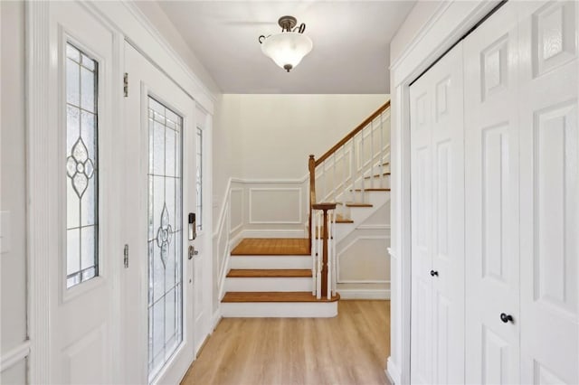 entrance foyer with a wealth of natural light and light hardwood / wood-style flooring