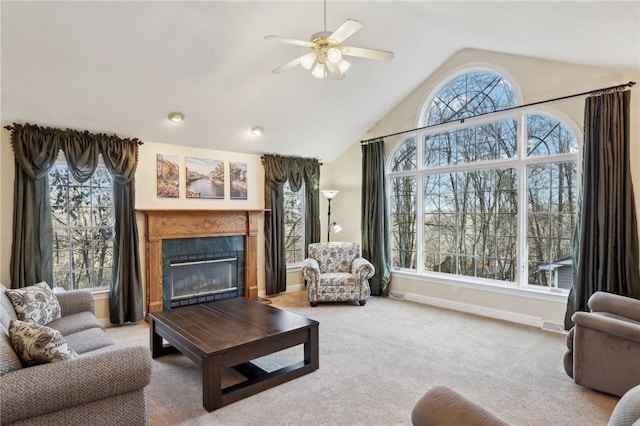 living room with carpet, ceiling fan, a fireplace, and a wealth of natural light