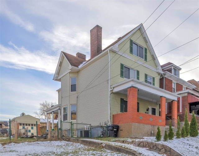 snow covered property with central air condition unit