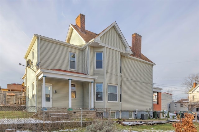 rear view of property featuring central AC unit