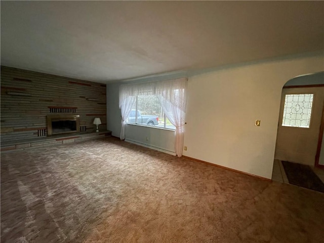 unfurnished living room featuring carpet flooring and a fireplace